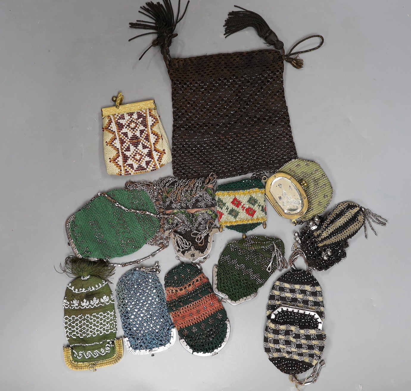 Nine wool and cut steel 19th century ladies coin purses, seven with metal frames and clasps, two with open bar tops, a similar bible bag with tassels and three bead work purses